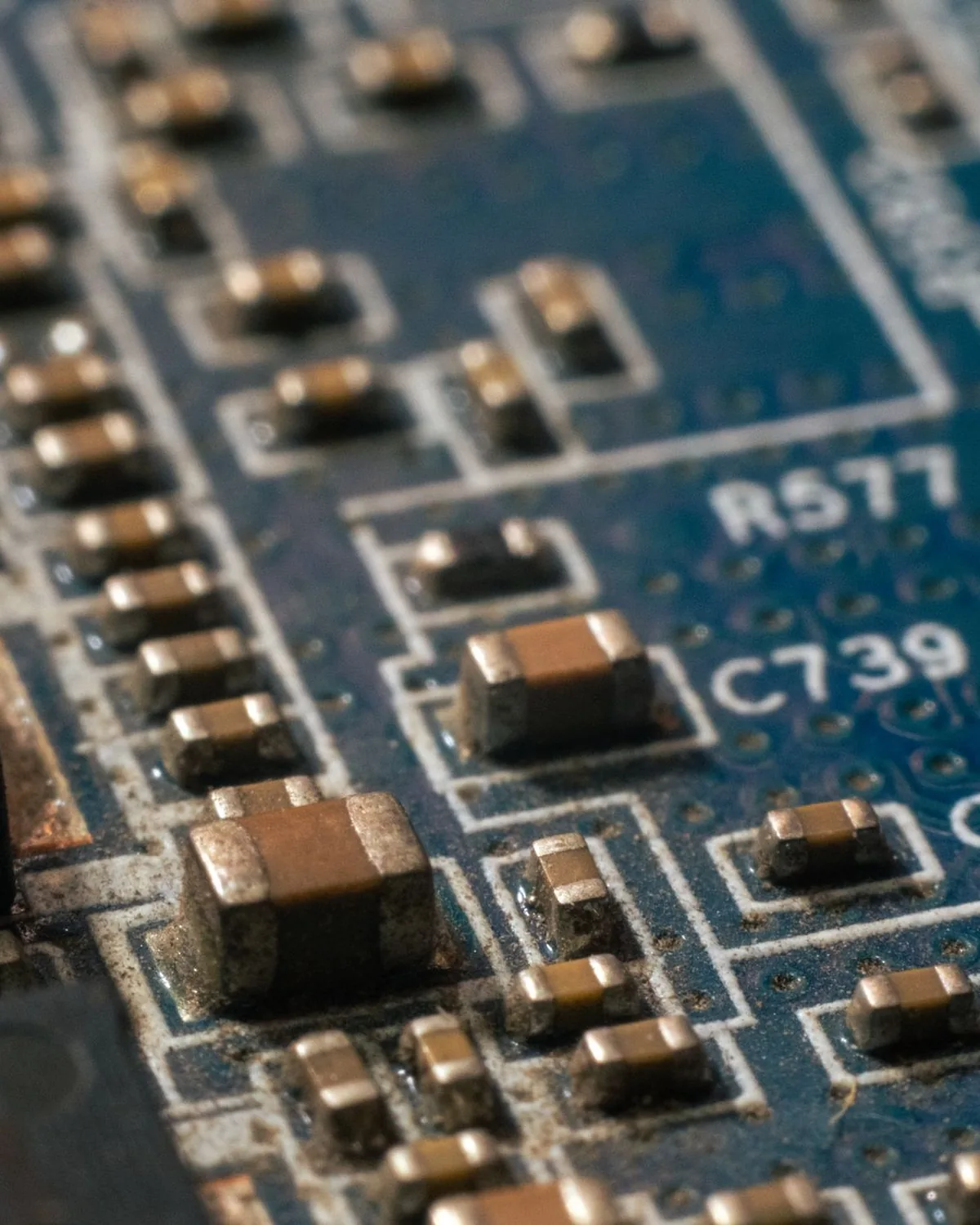 Close view of a circuit board crowded with soldered components and printed component labels.
