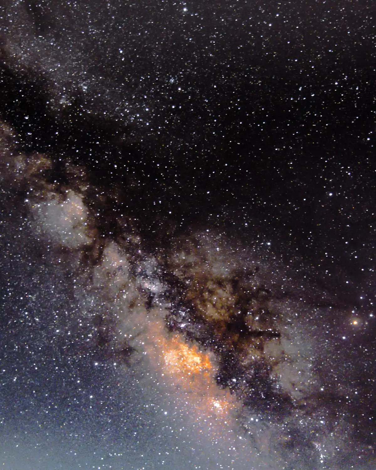 Long-exposure photograph of the Milky Way core, dense with stars and dark dust lanes.